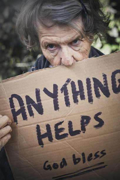 istock Senior woman holds sign appealing for help 1144992253