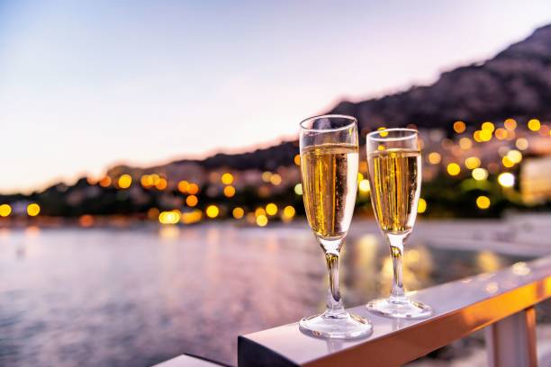 Champagne tasting & romantic atmosphere Champagne outdoors on terrace during celebration night event front of the sea, street lights in the background. monaco stock pictures, royalty-free photos & images