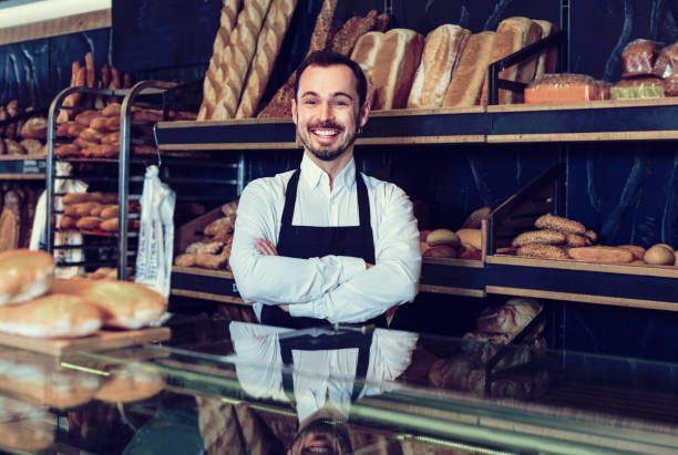 istock Man seller displaying assortment of bakery 1144994554