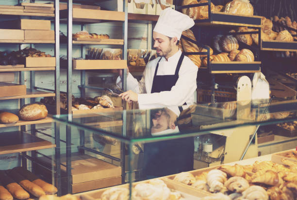 istock Young man is offering fresh tasty croissant 1144994582