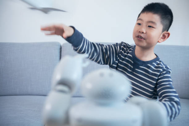 istock Smart boy flying model airplane indoors 1144995228