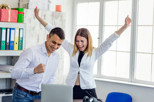 istock Cheerful coworkers working on computer in the office 1144995236