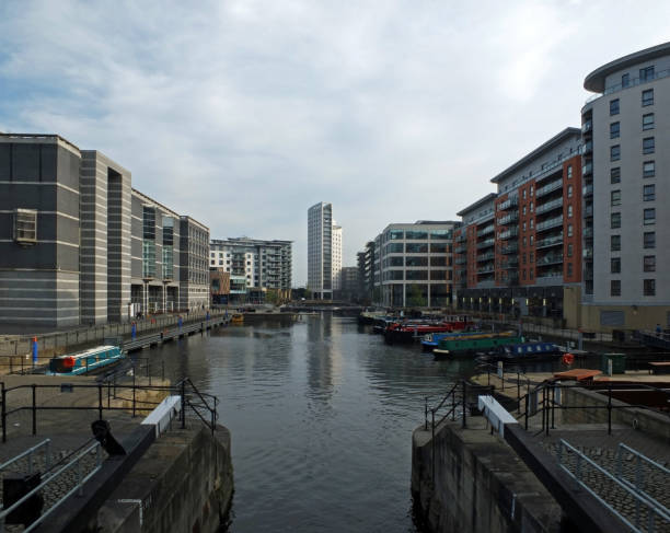 istock a view of leeds dock from the lock gates showing waterside developments offices and apartment buildings with houseboats moored in the water 1144995251