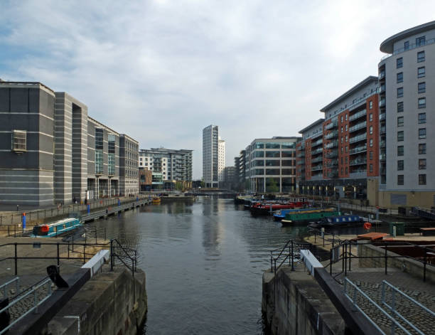 istock a view of leeds dock from the lock gates showing waterside developments offices and apartment buildings with houseboats moored in the water 1144995252