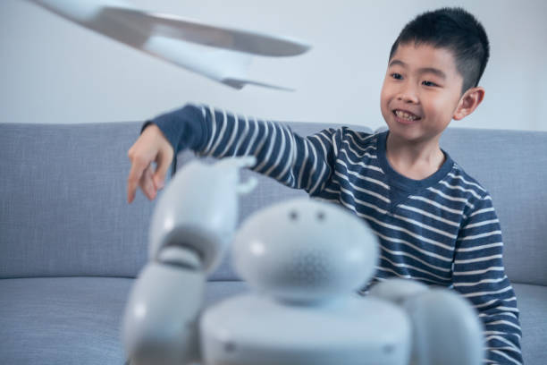 istock Smart boy flying model airplane indoors 1144995354