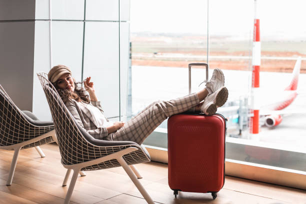 young beautiful woman in airport waiting room. - airport waiting room waiting airport lounge imagens e fotografias de stock