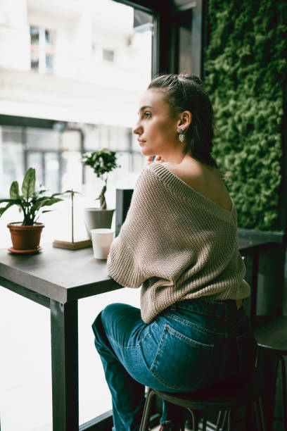 istock Female Beauty Drinking Coffee And Staring Through Window 1144995889