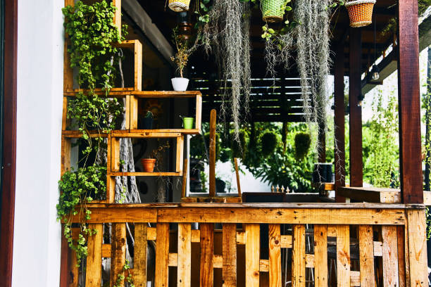 istock Multi-colored flower pots are hung on the ropes. 1144998758