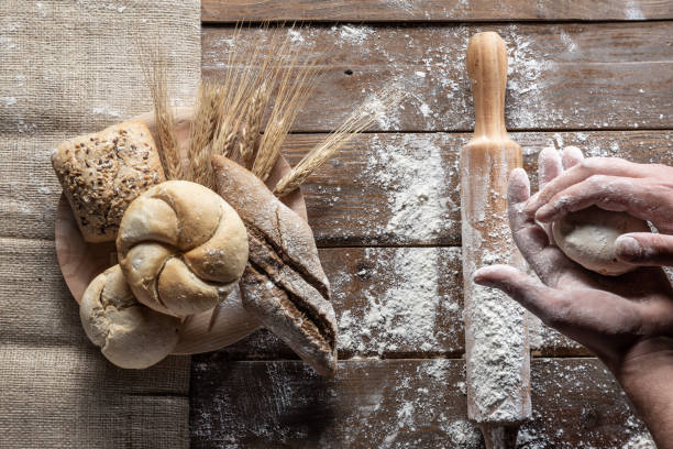 istock bread with wheat ears and flour on wood board, top view 1144999502