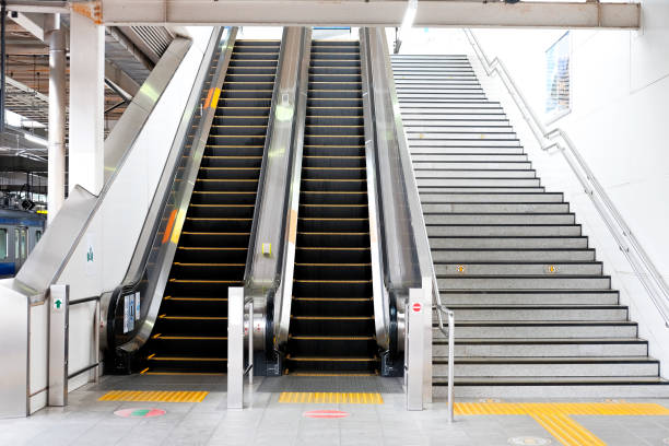 Modern luxury escalators facilities leading down into a Subway Station with Neon Lights, Moving Staircase Modern luxury escalators facilities leading down into a Subway Station with Neon Lights, Moving Staircase escalator stock pictures, royalty-free photos & images