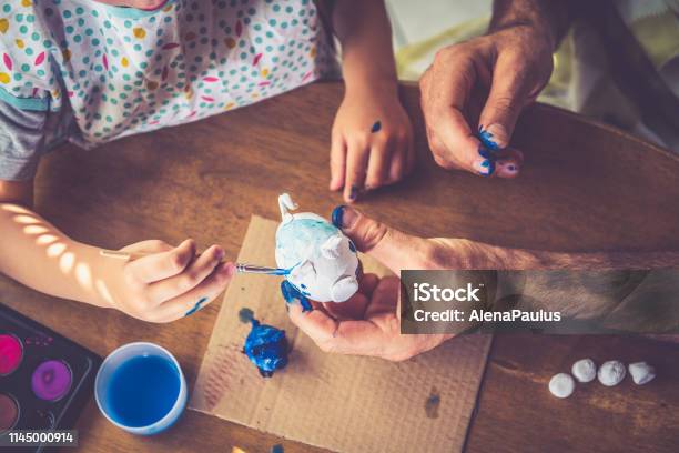 Father And Son Painting Clay Handmade Little Piggy Bank Stock Photo - Download Image Now