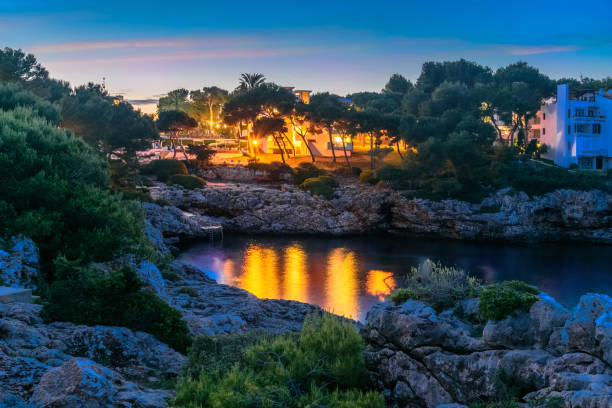 Night scene in Cala Dor region of Mallorca. Sea coast of Punta Grosa illuminated at dusk