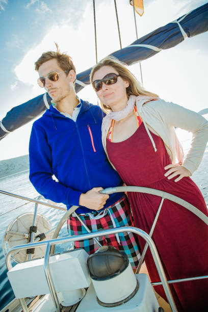 istock Young couple sailing on sailboat 1145002772