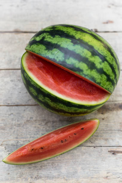 istock watermelon on a wooden table, piece of melon topview 1145002800