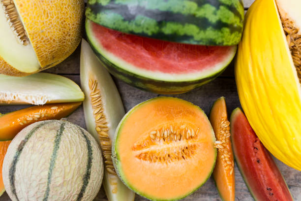 istock topview on a lot of different fresh melons, some are sliced, flat lay 1145002842