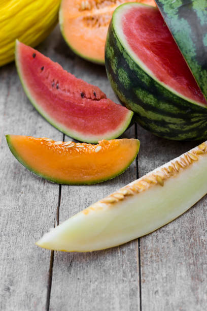 istock lot of different sliced melons on a wooden table 1145002846
