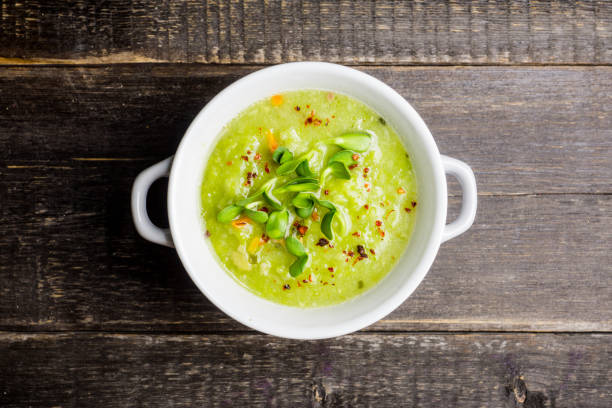 istock Hot green peas soup on the rustic background 1145004443