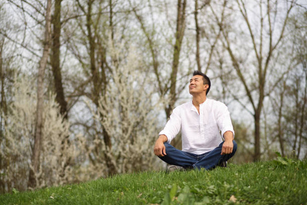 istock Japanese man sitting in nature 1145005696