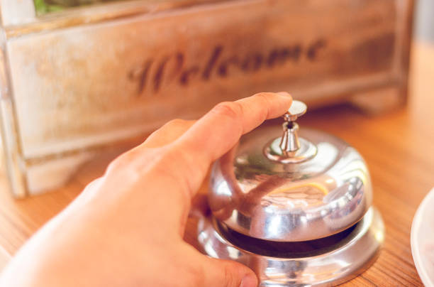 istock Hand ringing in service bell at hotel 1145007555