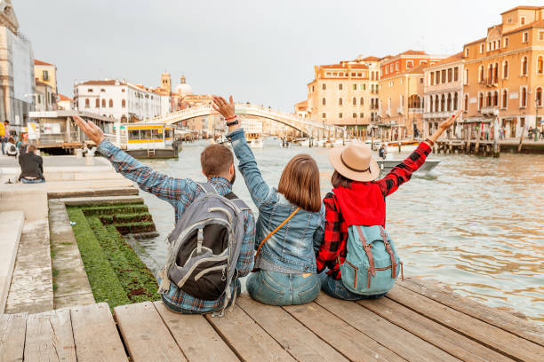 group of tourists at venice canal, travel and vacation for friends in italy and europe concept - group of objects travel friendship women imagens e fotografias de stock