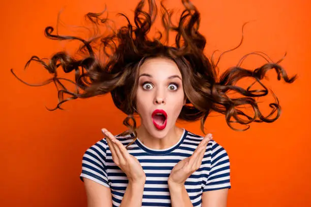 Close up photo beautiful she her lady red lipstick pomade hand arm palm raised hair curls flight unexpected epic fail wear casual striped white blue t-shirt clothes isolated orange bright background.