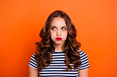 Close up photo beautiful she her lady red lipstick hold breath full mouth air ignore not listen speak talk tell look up wear casual striped white blue t-shirt clothes isolated orange bright background