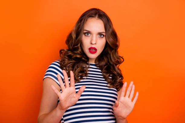 istock Close up photo beautiful she her lady red lipstick pomade ask stand still calm down pull over make pause off quit wear casual striped white blue t-shirt clothes isolated orange bright background 1145012873
