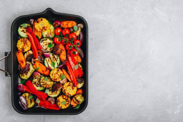 Grilled vegetables in a cast iron pan. Top view. Grilled vegetables in a cast iron pan. Top view, copy space roasted stock pictures, royalty-free photos & images