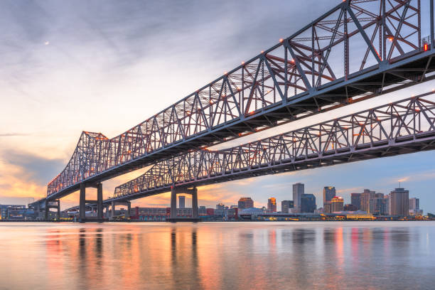 New Orleans, Louisiana, USA at Crescent City Connection Bridge over the Mississippi River. New Orleans, Louisiana, USA at Crescent City Connection Bridge over the Mississippi River at dusk. new orleans stock pictures, royalty-free photos & images