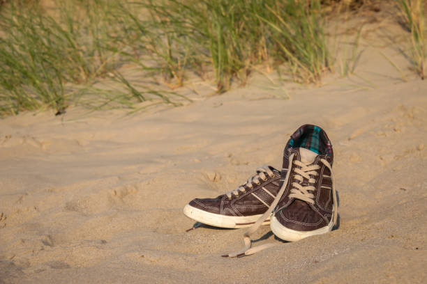 istock Sneakers on the beach 1145025755