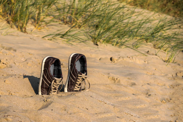 Shoes are stuck in the sand at the beach