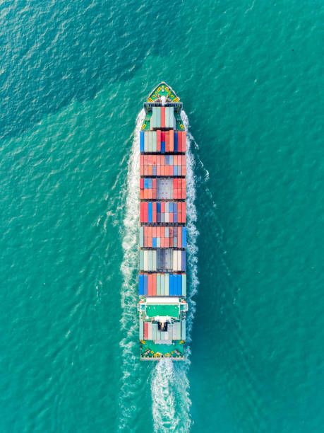istock Aerial top view container ship on the seaa full speed delivering container for logistics, import export, shipping or transportation. 1145027620