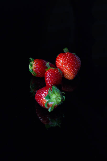 istock Fresh strawberries isolated on black background with reflections 1145030328