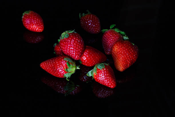 istock Fresh strawberries isolated on black background with reflections 1145030336