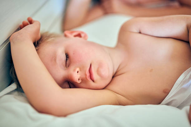 istock Toddler boy sleeping on pillow with mother 1145032927