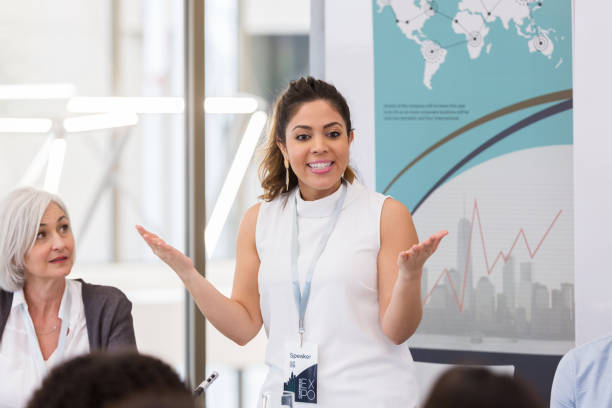 istock Businesswoman gestures while giving speech during conference 1145034553