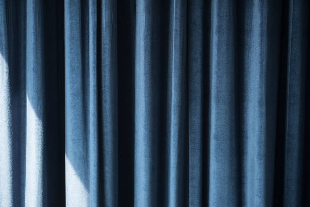 istock Beautifully draped blue curtain decoration in room 1145036304