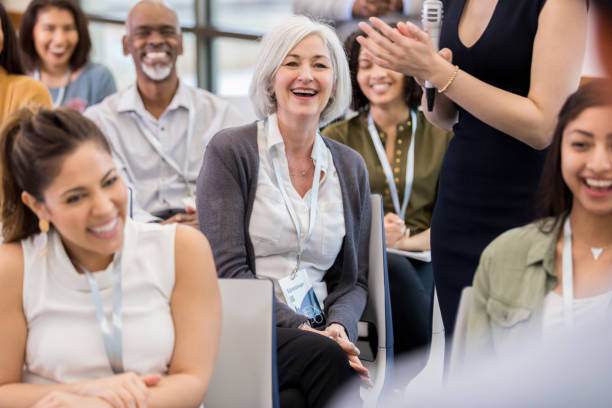 istock Woman enjoys speaker during conference 1145040669
