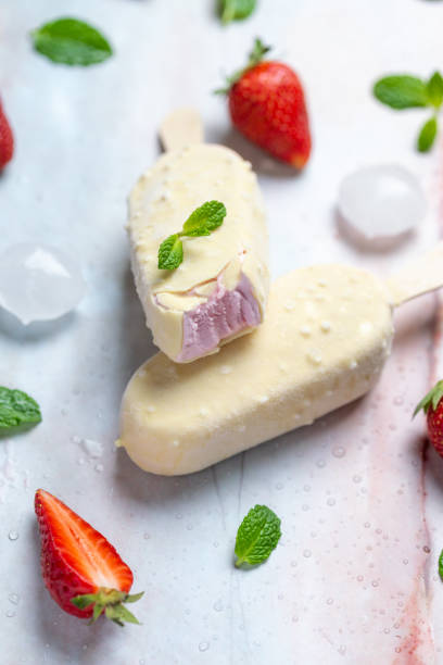 istock Strawberry ice cream on stick covered with white chocolate 1145040788