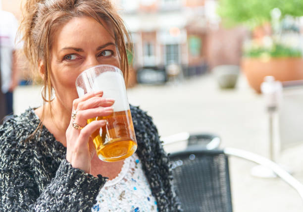 Elaine drinking pints of real beer stock photo