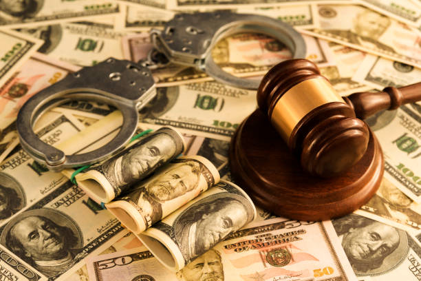 istock handcuffs, judge's hammer, American dollar bills. 1145041214