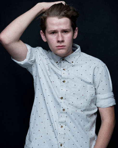 istock Young handsome man standing in front of black background 1145043831