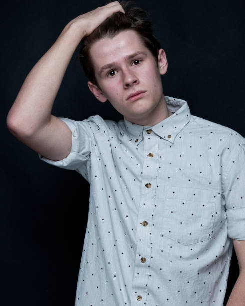 istock Young handsome man standing in front of black background 1145044010