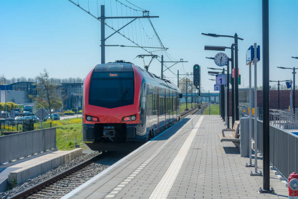 Red train entering Waddinxveen new district Triangel Station