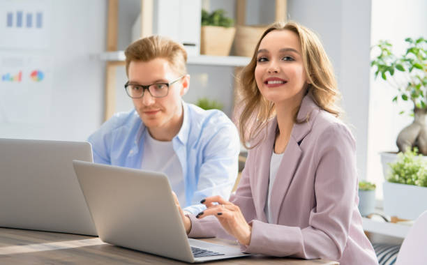 istock man and woman working in the office 1145045583