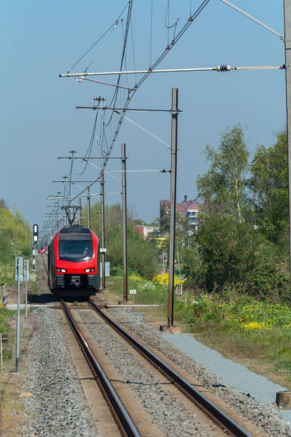 Red train entering Waddinxveen new district Triangel Station