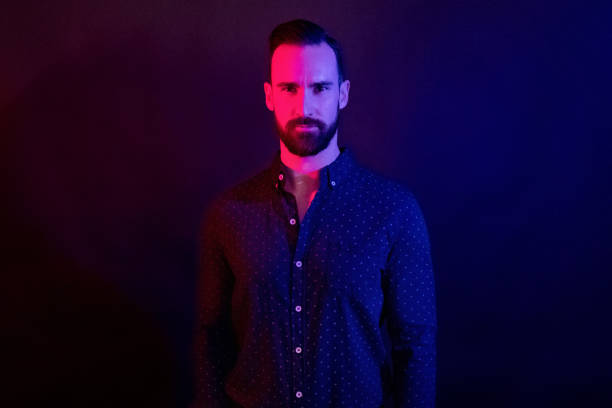 istock Handsome man with blue shirt with color lighting 1145048104