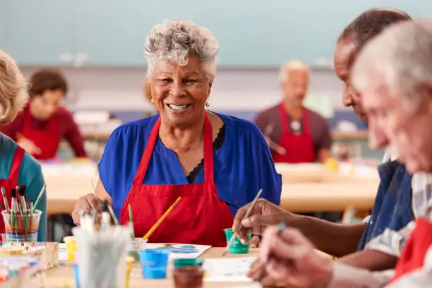 Photo of Portrait Of Retired Senior Woman Attending Art Class In Community Centre