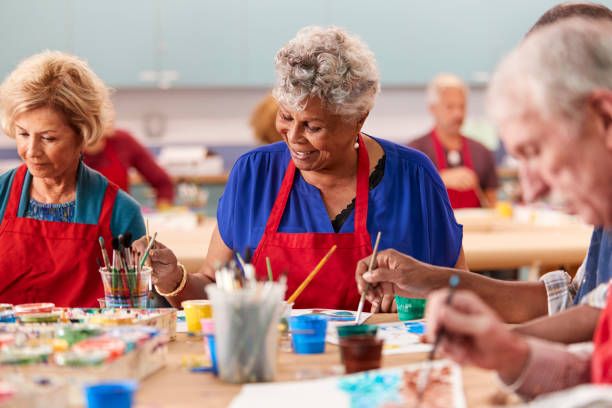 istock Retired Senior Woman Attending Art Class In Community Centre 1145048325