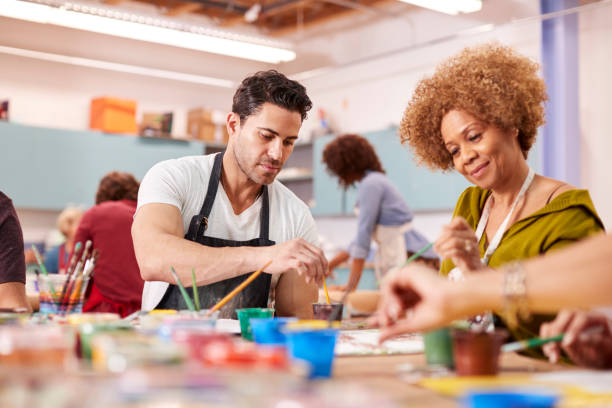 istock Group Of Mature Adults Attending Art Class In Community Centre 1145048444